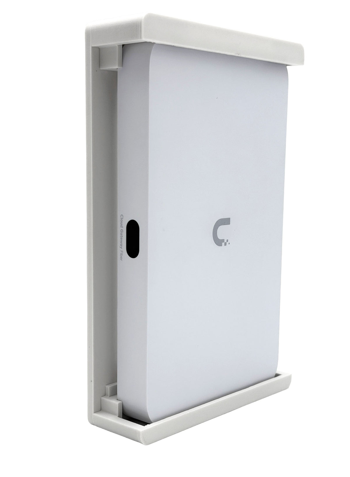 HangLab wall mount for the Ubiquiti UCG-Fiber, white, three-quarter view with the gateway in place